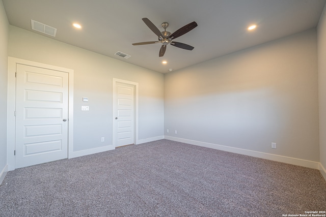 unfurnished room featuring ceiling fan and carpet flooring