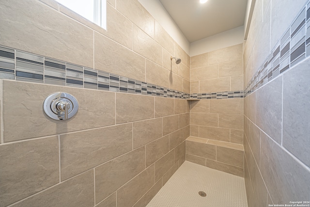 bathroom with a tile shower