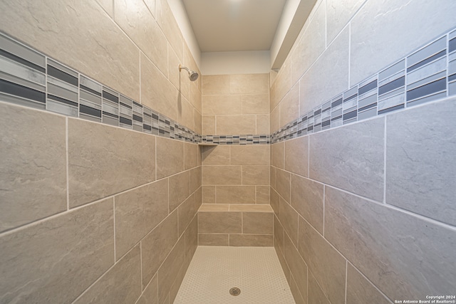 bathroom with a tile shower