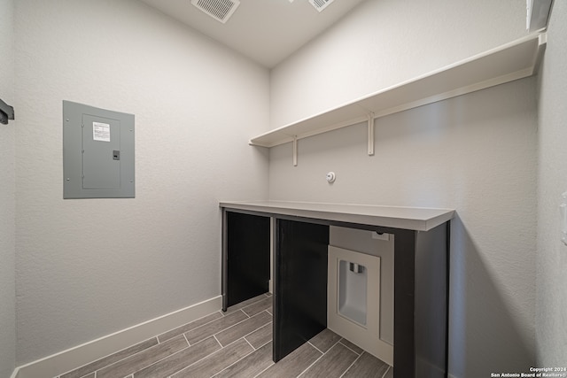 laundry area with electric panel