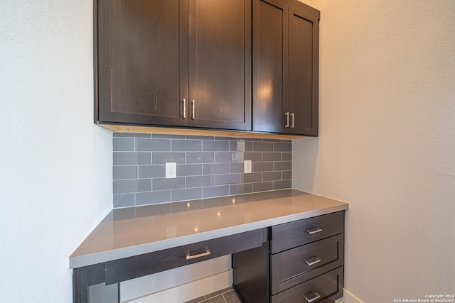 kitchen with dark brown cabinetry and backsplash