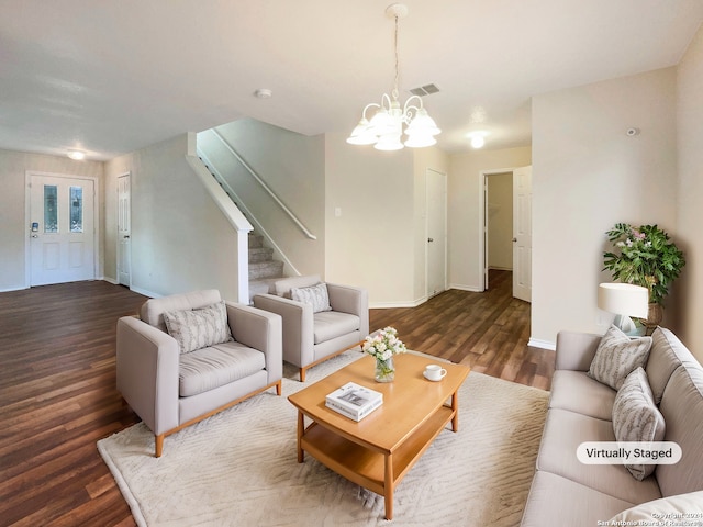 living room with an inviting chandelier and dark hardwood / wood-style floors