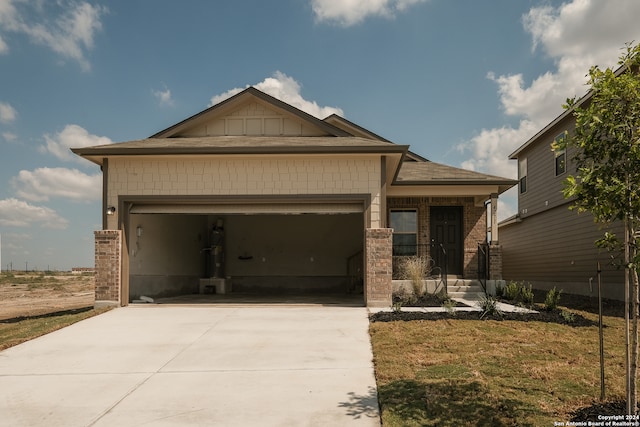 craftsman inspired home with a front yard and a garage