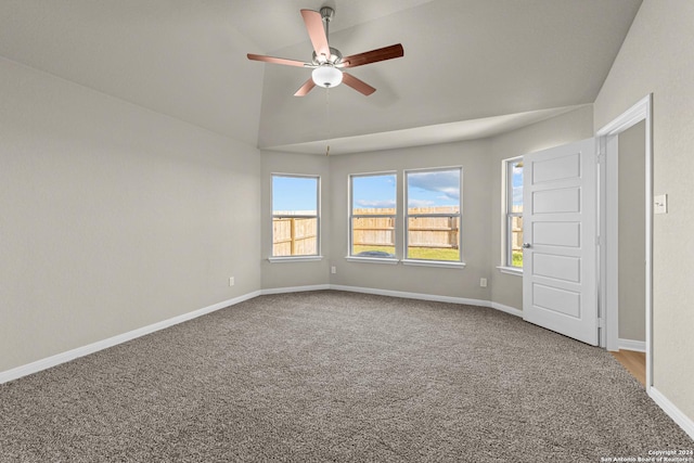 carpeted empty room featuring ceiling fan and lofted ceiling