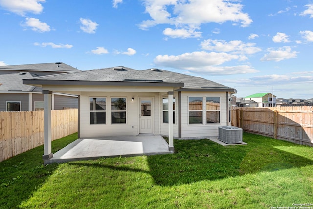 back of property featuring a lawn, a patio area, and cooling unit