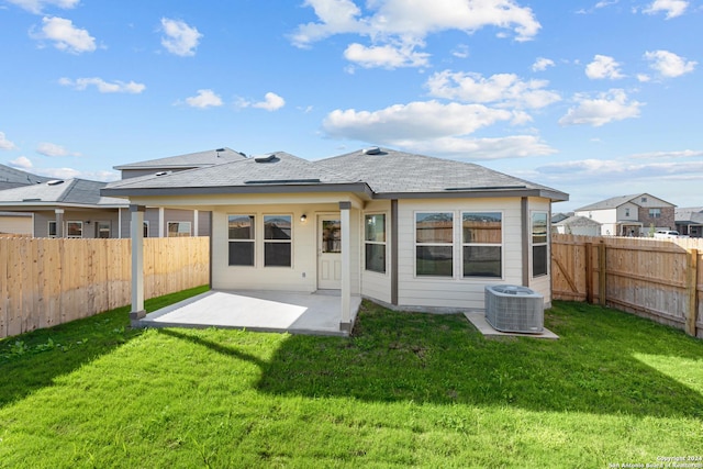 back of house featuring a yard, a patio, and central AC