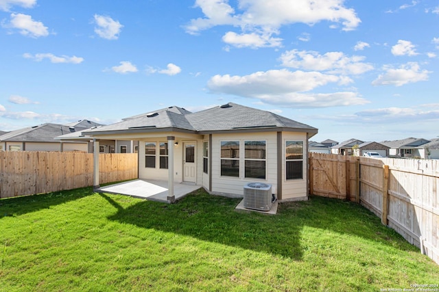 back of house featuring a patio, central AC unit, and a lawn