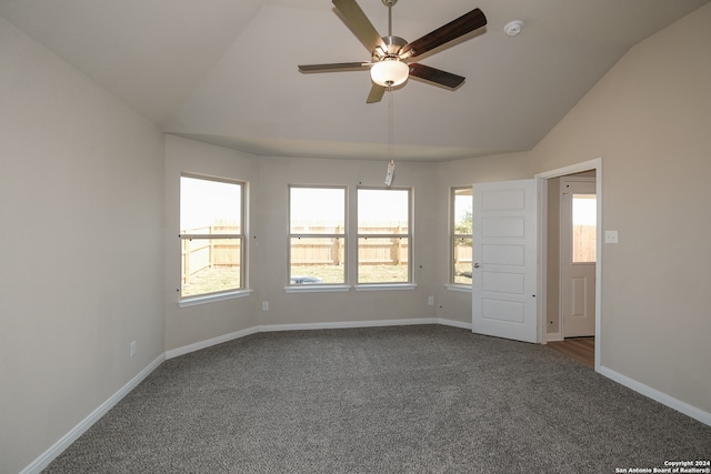 carpeted empty room featuring ceiling fan and lofted ceiling