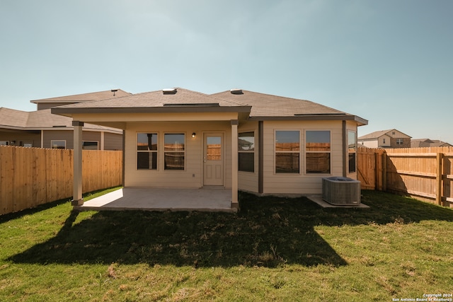 rear view of property with a patio area, a yard, and central air condition unit