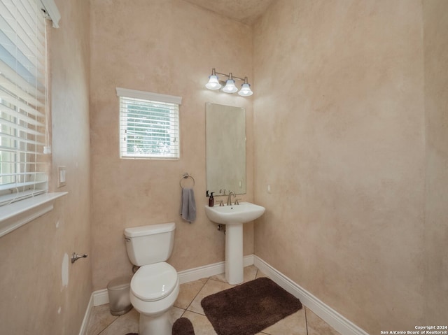 bathroom featuring toilet and tile patterned floors