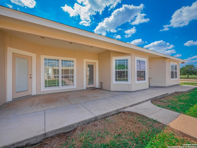 doorway to property with a patio