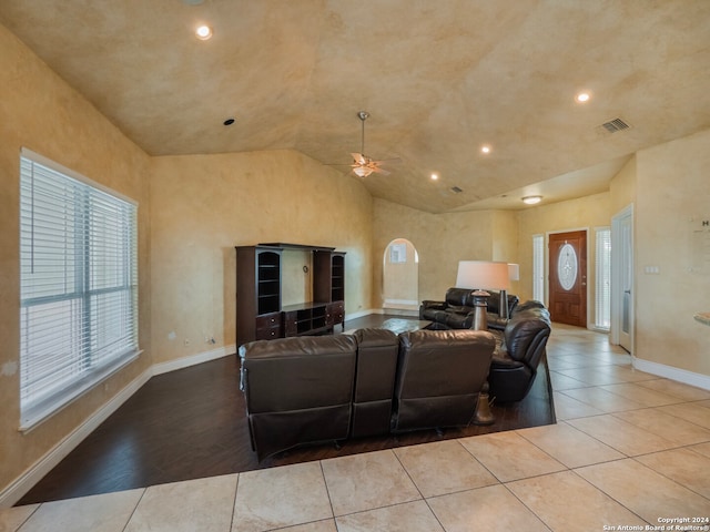 living room featuring lofted ceiling, ceiling fan, and light hardwood / wood-style flooring