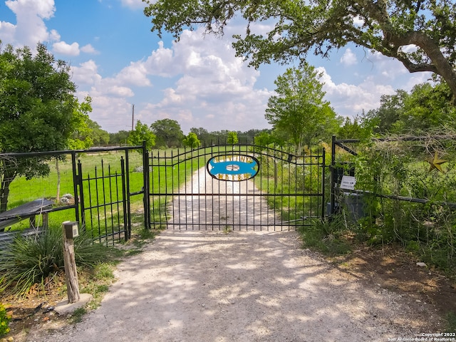 view of gate with a yard