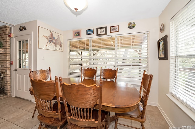 dining area with light tile patterned flooring and a textured ceiling