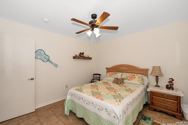 tiled bedroom with ceiling fan