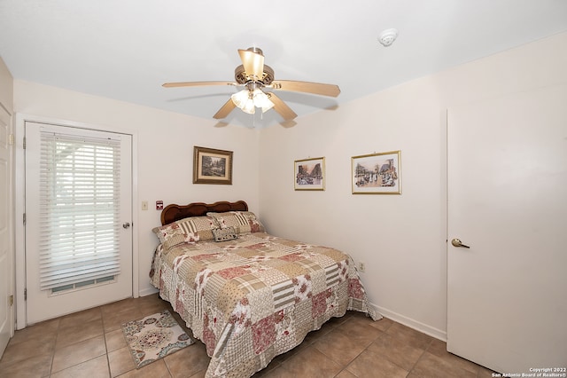 tiled bedroom featuring ceiling fan