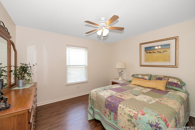 bedroom with ceiling fan and dark hardwood / wood-style flooring