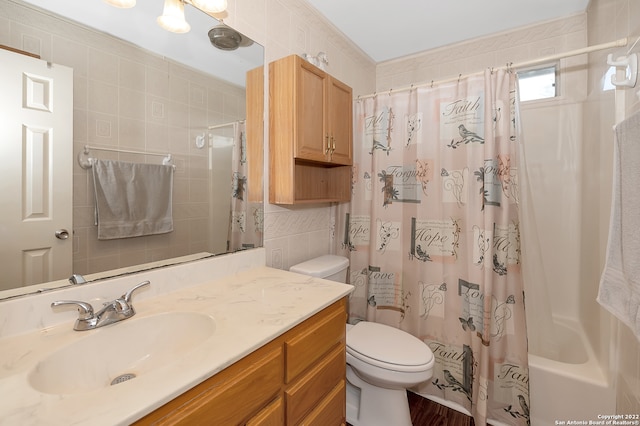 full bathroom with shower / bath combination with curtain, vanity, tile walls, and toilet