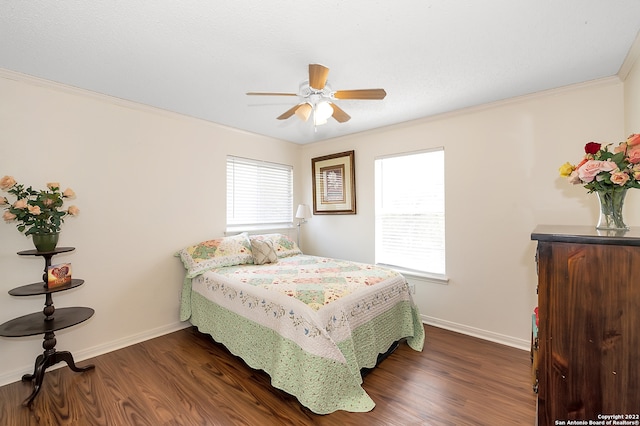 bedroom with ornamental molding, dark hardwood / wood-style flooring, and ceiling fan