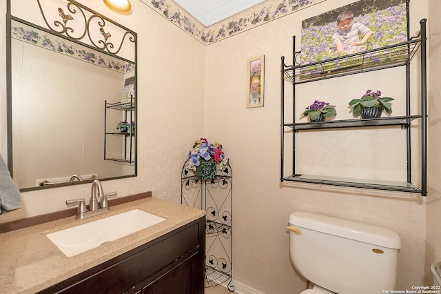 bathroom featuring crown molding, vanity, and toilet