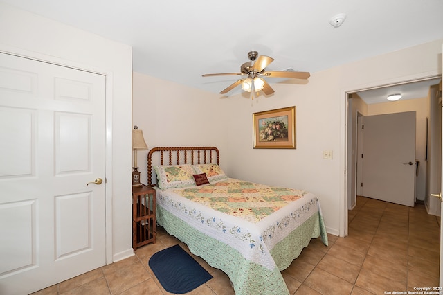 tiled bedroom with ceiling fan