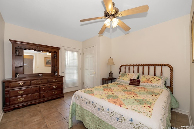 tiled bedroom featuring ceiling fan