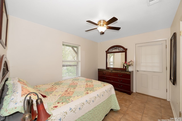 bedroom with ceiling fan and light tile patterned flooring