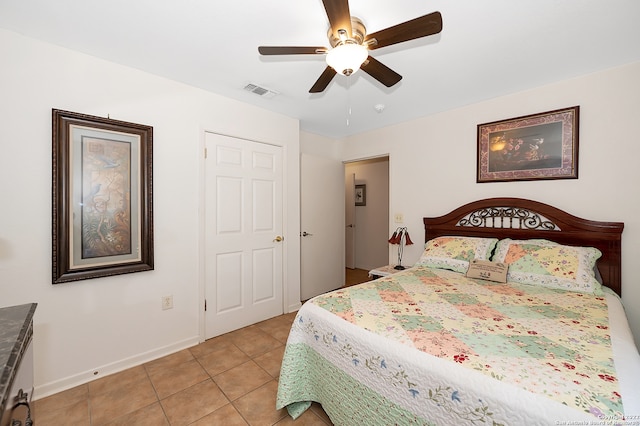 bedroom with ceiling fan and light tile patterned floors