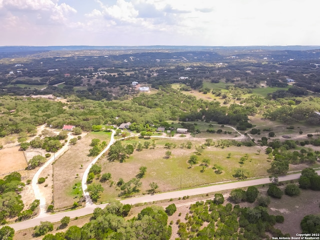 birds eye view of property with a rural view