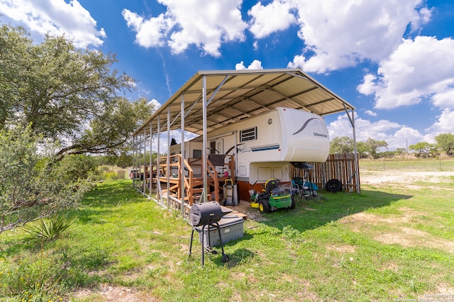 exterior space with a yard and a carport