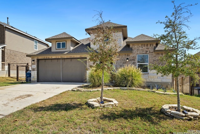 view of front facade with a garage and a front lawn