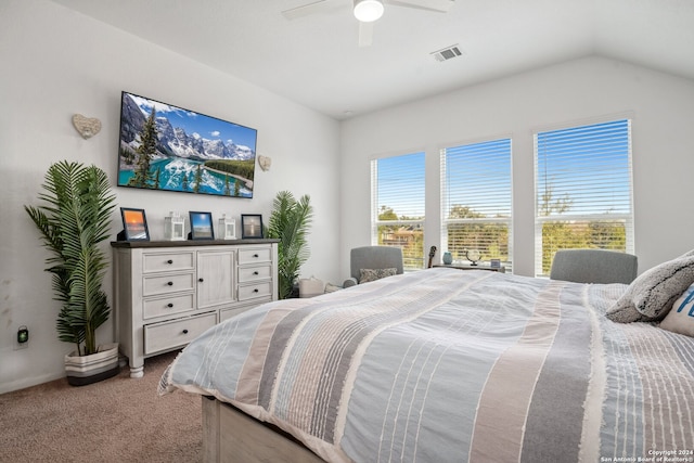 bedroom with ceiling fan, vaulted ceiling, and carpet