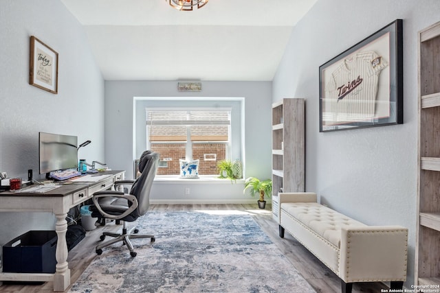 office featuring vaulted ceiling and hardwood / wood-style floors