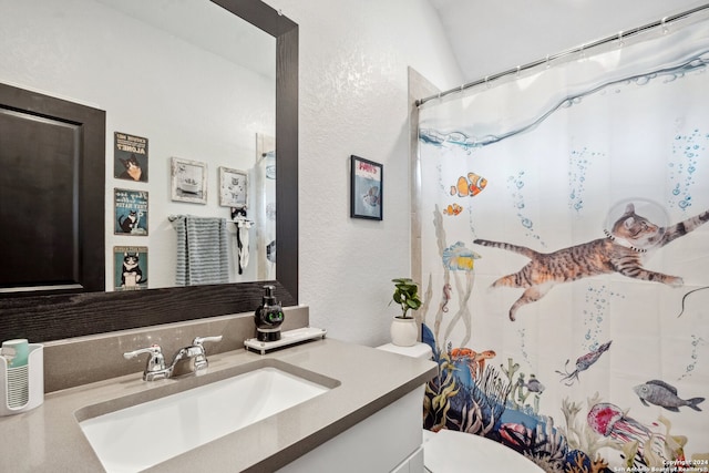 bathroom with lofted ceiling, a shower with shower curtain, vanity, and toilet