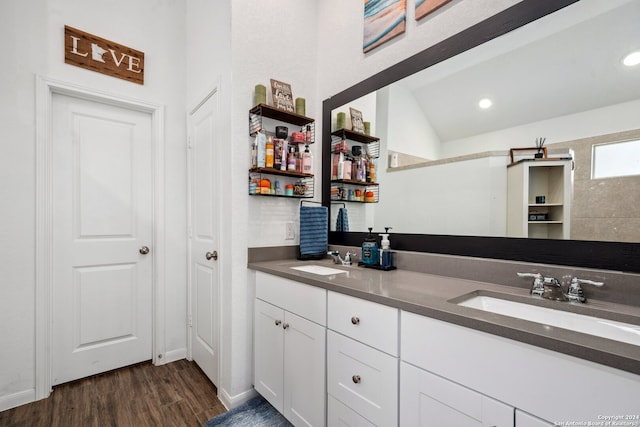 bathroom with vanity, lofted ceiling, and hardwood / wood-style flooring