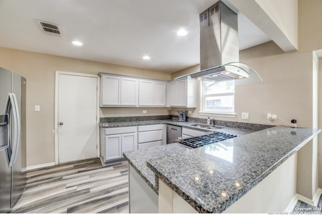 kitchen featuring kitchen peninsula, white cabinets, and stainless steel fridge with ice dispenser