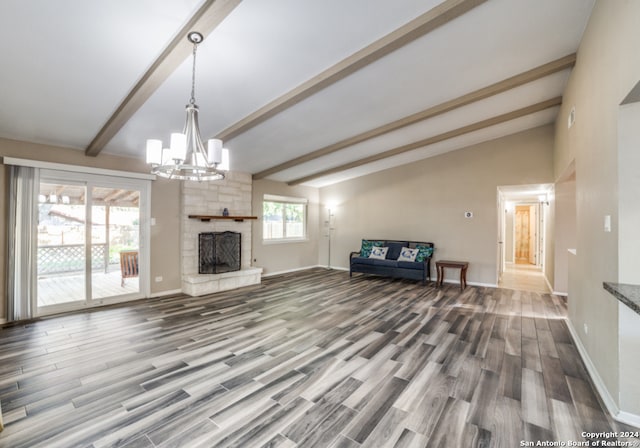 unfurnished living room with a fireplace, plenty of natural light, hardwood / wood-style floors, and vaulted ceiling with beams