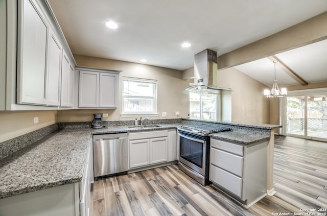 kitchen featuring sink, exhaust hood, appliances with stainless steel finishes, dark stone countertops, and light wood-type flooring