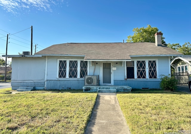 view of front of home with a front yard and ac unit