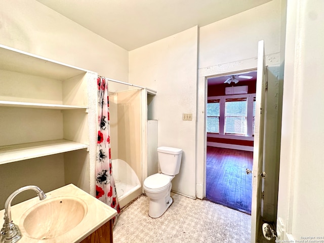 bathroom with toilet, hardwood / wood-style floors, a shower with shower curtain, and vanity