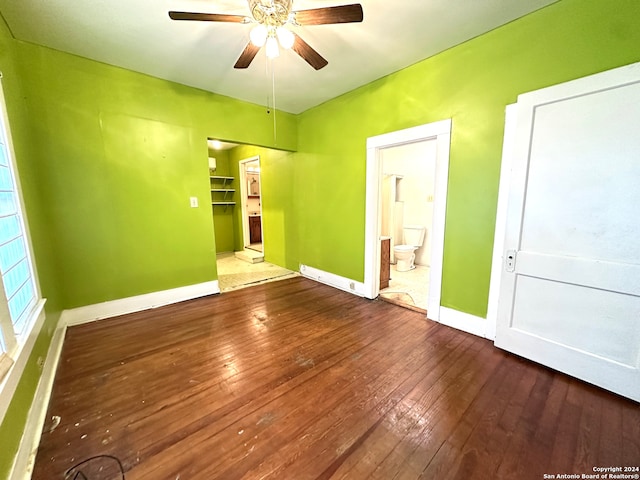 unfurnished bedroom featuring a closet, ceiling fan, hardwood / wood-style floors, and ensuite bath