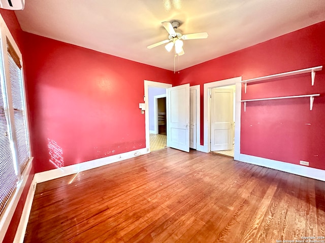 unfurnished bedroom featuring a closet, hardwood / wood-style flooring, and ceiling fan