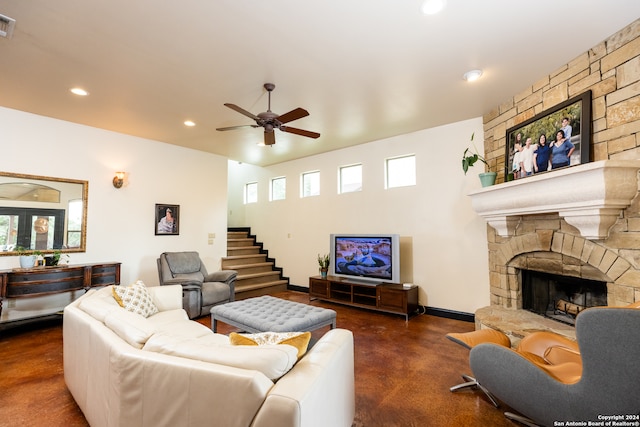 living room featuring a fireplace and ceiling fan