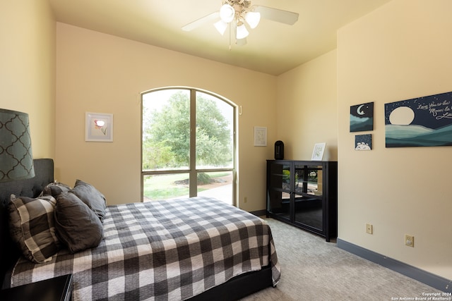 carpeted bedroom featuring ceiling fan and access to exterior