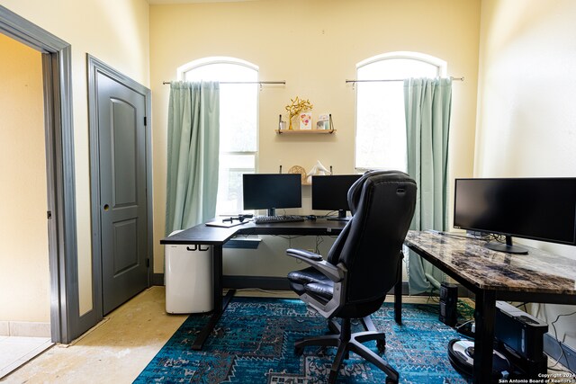 home office with concrete flooring