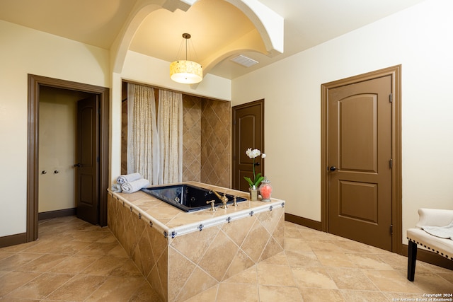 bathroom featuring tiled bath