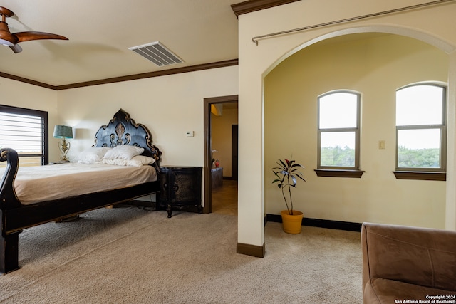 bedroom featuring ornamental molding, ceiling fan, and light colored carpet