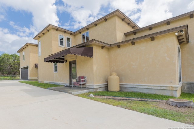 rear view of property featuring a garage