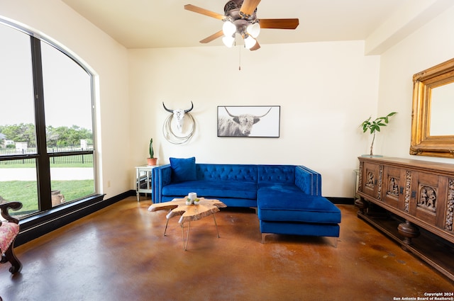 living room with ceiling fan and concrete flooring