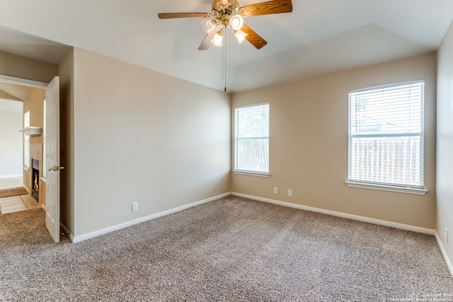 empty room with light carpet, plenty of natural light, and ceiling fan